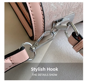 Detail of silver metallic hook on pink floral jacquard shoulder bag with leather strap