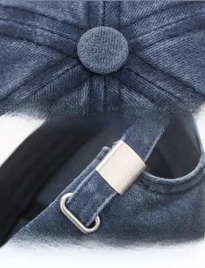 Detailed view of the radial stitching and adjustable metal buckle on navy baseball cap