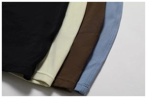 Macro shot showing double-needle stitching on yoga bodysuit hem in four colors