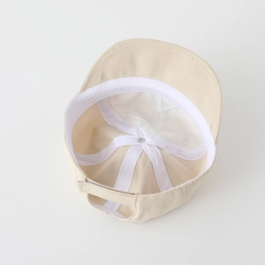 Detail view of cotton baby hat interior showing white sweatband and adjustable strap