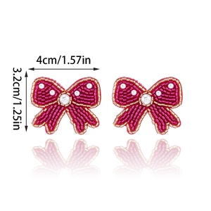 Bohemian rose red beaded bow earrings with gold accents and central white pearl details