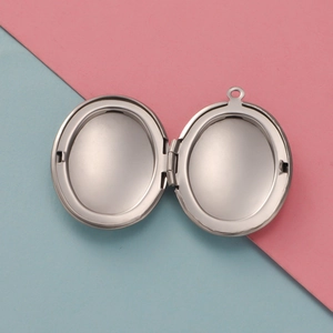 Macro view of a 316L stainless steel oval locket showing two internal photo slots