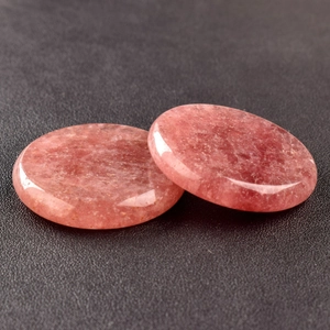 Macro shot of polished 40mm round pink strawberry quartz stones with natural textures