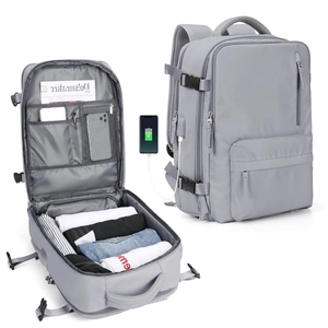 Internal compartments of grey travel backpack showing laptop storage and USB charging port