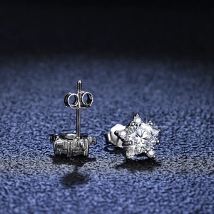 Macro view of star-shaped S925 silver stud earrings with brilliant moissanite stones