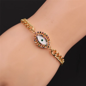 Detailed view of a gold-plated evil eye bracelet featuring colorful cubic zirconia on wrist