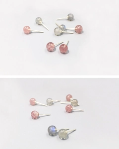 Detailed macro shot of S999 silver stud earrings featuring pink strawberry quartz beads