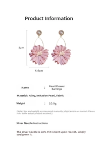Detailed view of pink fabric flower earrings with faux pearls and silver needles