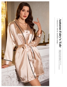 Elegant champagne silk robe with black piping detail and waist tie on female model