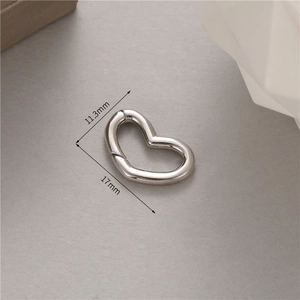 Macro shot of silver heart spring clasp jewelry connector with dimensions 17x11.3mm