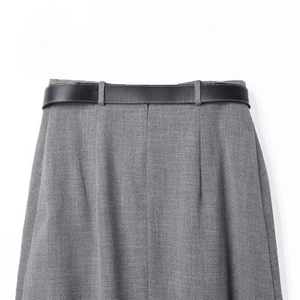 Detailed view of the grey skirt waist area with a classic slim black leather belt