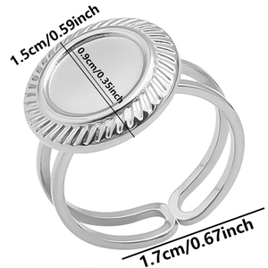 Detail view of adjustable silver steel ring featuring oval flat base with radial texture