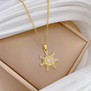Titanium steel snowflake necklace with sparkling crystals on beige jewelry box