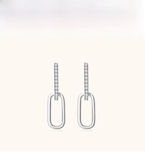 Detailed view of silver geometric double-loop earrings with pave moissanite accents