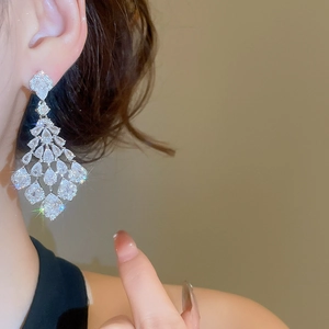 Elegant silver tassel earrings with sparkling zircon teardrops on a model wearing them
