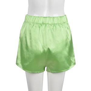 Detail of green satin shorts with elastic waistband and silky texture on mannequin