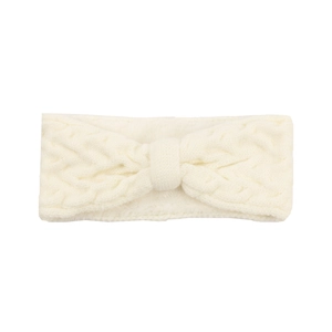 Close-up of cream knit winter headband with twist knot and plush cable stitch texture