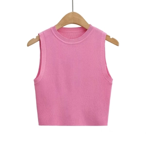 Pink Y2K sleeveless knitted crop top for women with crew neck on a wooden hanger