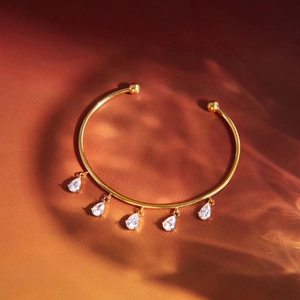 Classic 18K gold-plated stainless steel open bangle with pear-cut zircon tassels