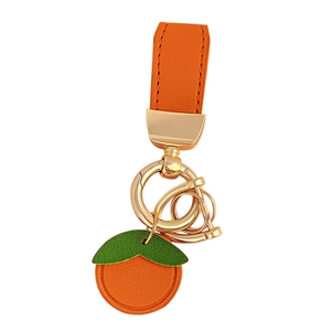 Cute orange leather fruit keychain with green leaf and golden metal ring hardware