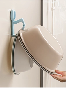 Wall-mounted bathroom basin hook holding multiple nested washbasins in a side view