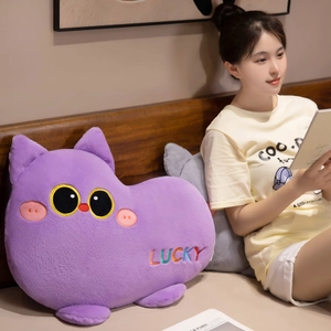 Plush purple cat throw pillow with cute embroidery in a cozy bedroom setting