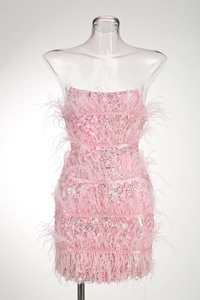 Detailed view of pink sequin party dress with strapless neck and ostrich feather hem