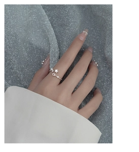 Close-up of s925 silver open star ring with sparkling zircons on a model's finger