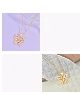 Macro detail of butterfly pendant necklace with inlaid zircon stones in golden finish