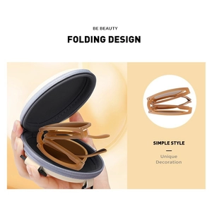 Macro detail of amber folding sunglasses with a portable round zipper storage case