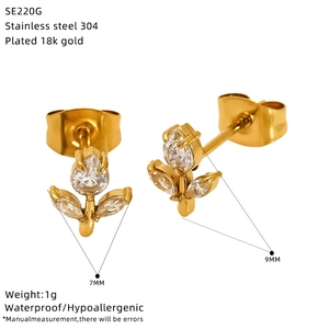 Detail view of 18k gold plated stainless steel stud earrings with zircon floral accents
