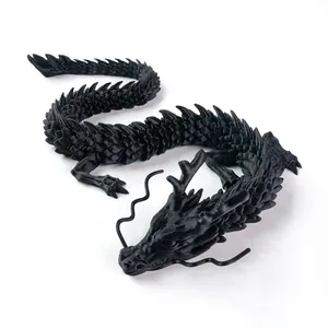 Top view of a flexible 3D printed dragon figurine in black with movable joints