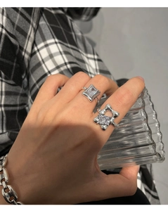 Detail of 925 sterling silver square diamond ring on model with irregular star design