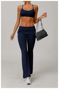 Detail of high-waist flared yoga pants and U-neck sports bra in deep blue