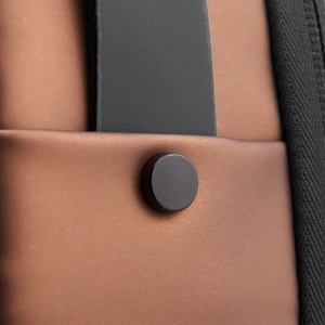 Close-up of waterproof brown fabric texture with black buckle and durable stitching