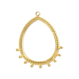 Detailed view of a golden teardrop pendant with hammered texture and small bead accents