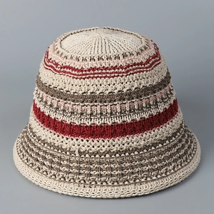 Detailed knit texture of a colorful crochet bucket hat with red and brown stripes