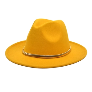 Detailed close-up of golden felt fedora with a stylish metallic gold band decoration