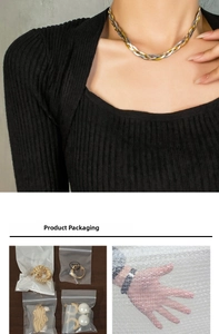 Detailed view of triple-strand snake chain necklace with its protective packaging set