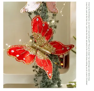 Macro shot of red velvet Christmas butterfly ornament with gold glitter on pine branch