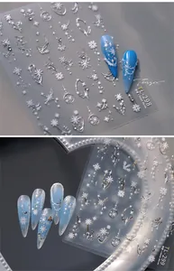 Macro shot of 5D embossed Christmas snowflake nail stickers with silver star patterns