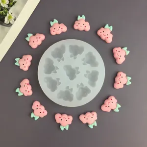 Macro view of 9-cavity silicone mold with pink cloud-shaped crafts and measurements