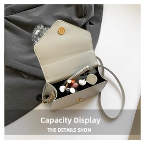 Detail view showing interior capacity of ivory leather crossbody bag with magnetic buckle