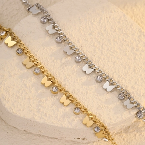 Gold and silver butterfly zircon stainless steel bracelets on stone background