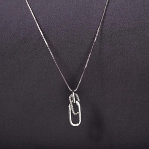 Detail of interlocking silver oval rings with micro-pave cubic zirconia on a cable chain