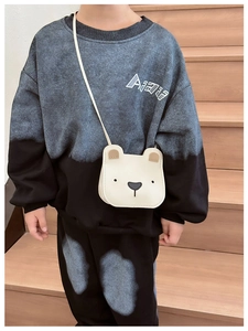 Detail of cute white bear crossbody bag paired with kids tie-dye tracksuit set