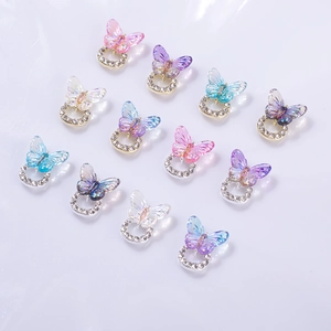 Detail of 3D crystal butterfly nail charms with aurora finish and rhinestone base
