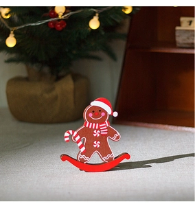 Close-up of wooden gingerbread man rocking horse ornament with festive scarf and hat