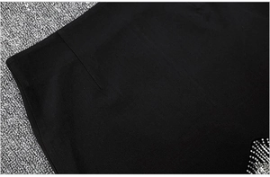 Detail of black fabric with sparkling rhinestone patterns and refined stitching