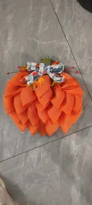 Detailed view of handmade pumpkin wreath with orange mesh, maple leaves and floral bow